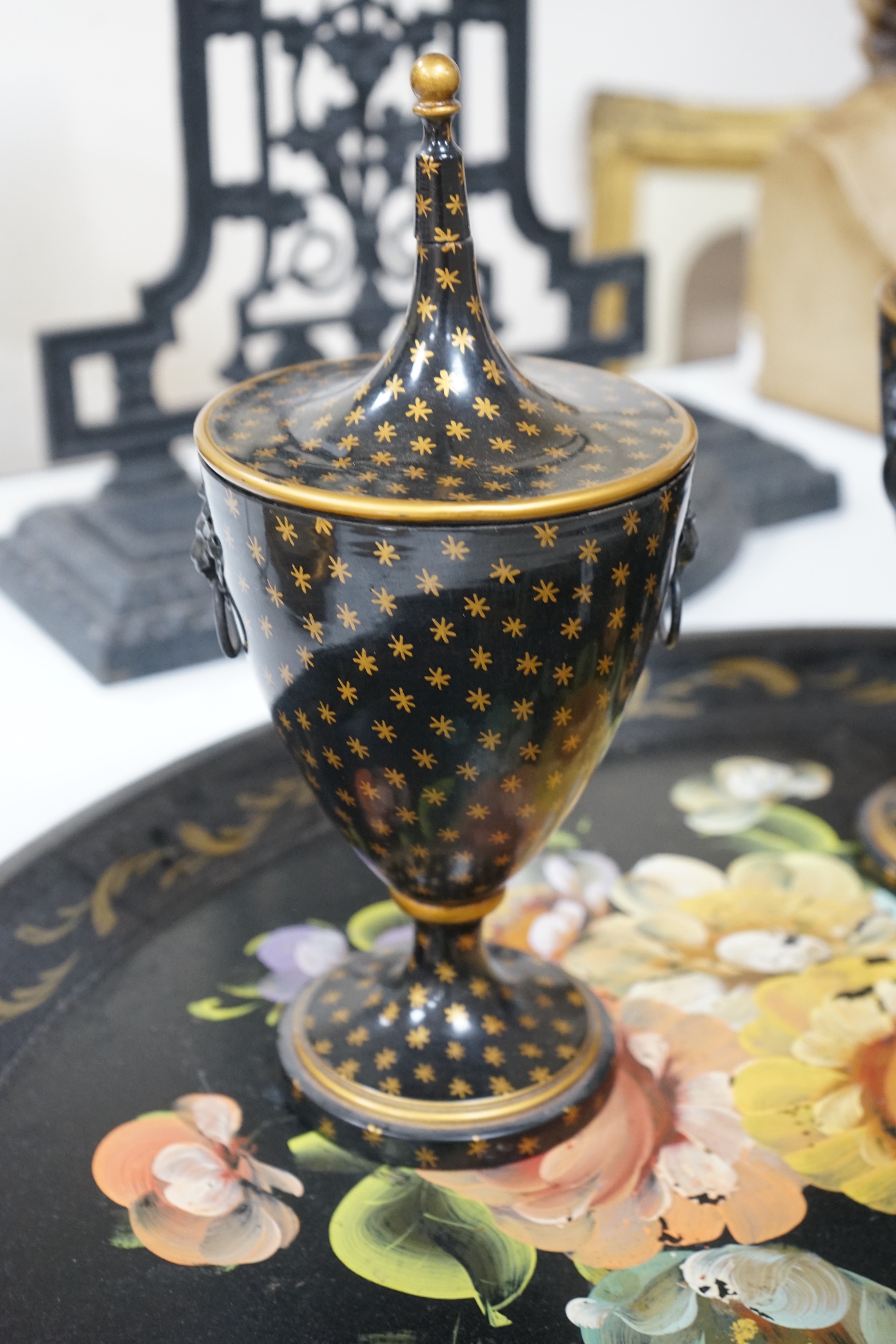 A pair of lidded painted toleware vessels, together with a painted tin toleware tray, 65cm long (3)